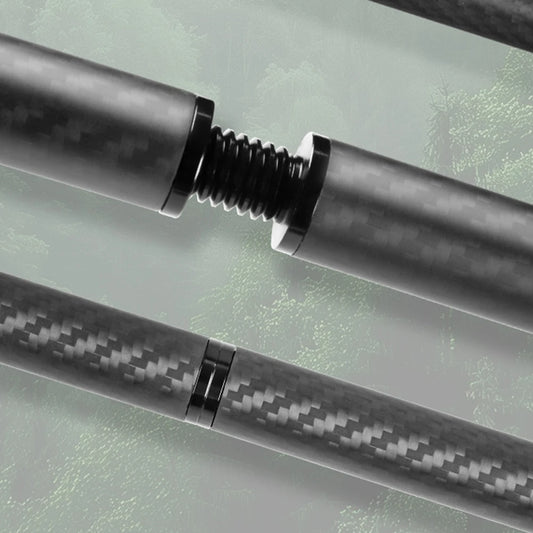 Close-up of a carbon fiber rod with a metallic fitting on a reflective surface
