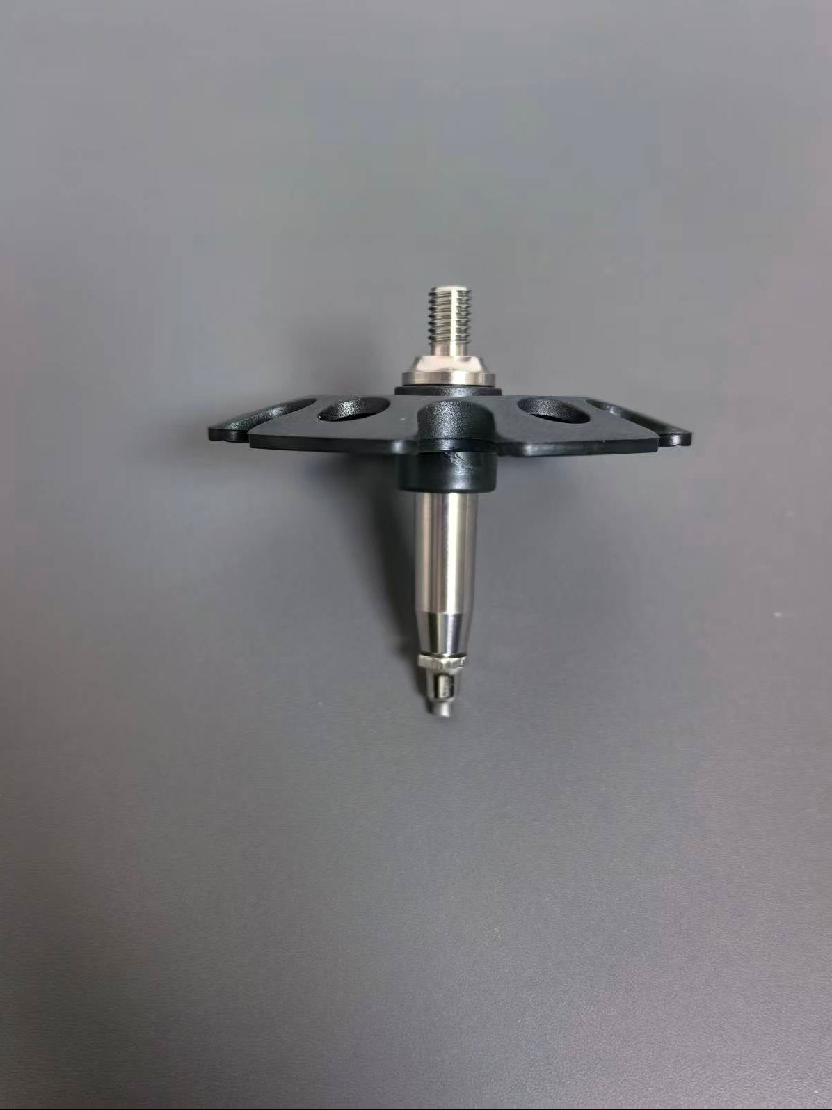A black plastic mounting bracket with a silver metal threaded post and pin, shown against a plain gray background.